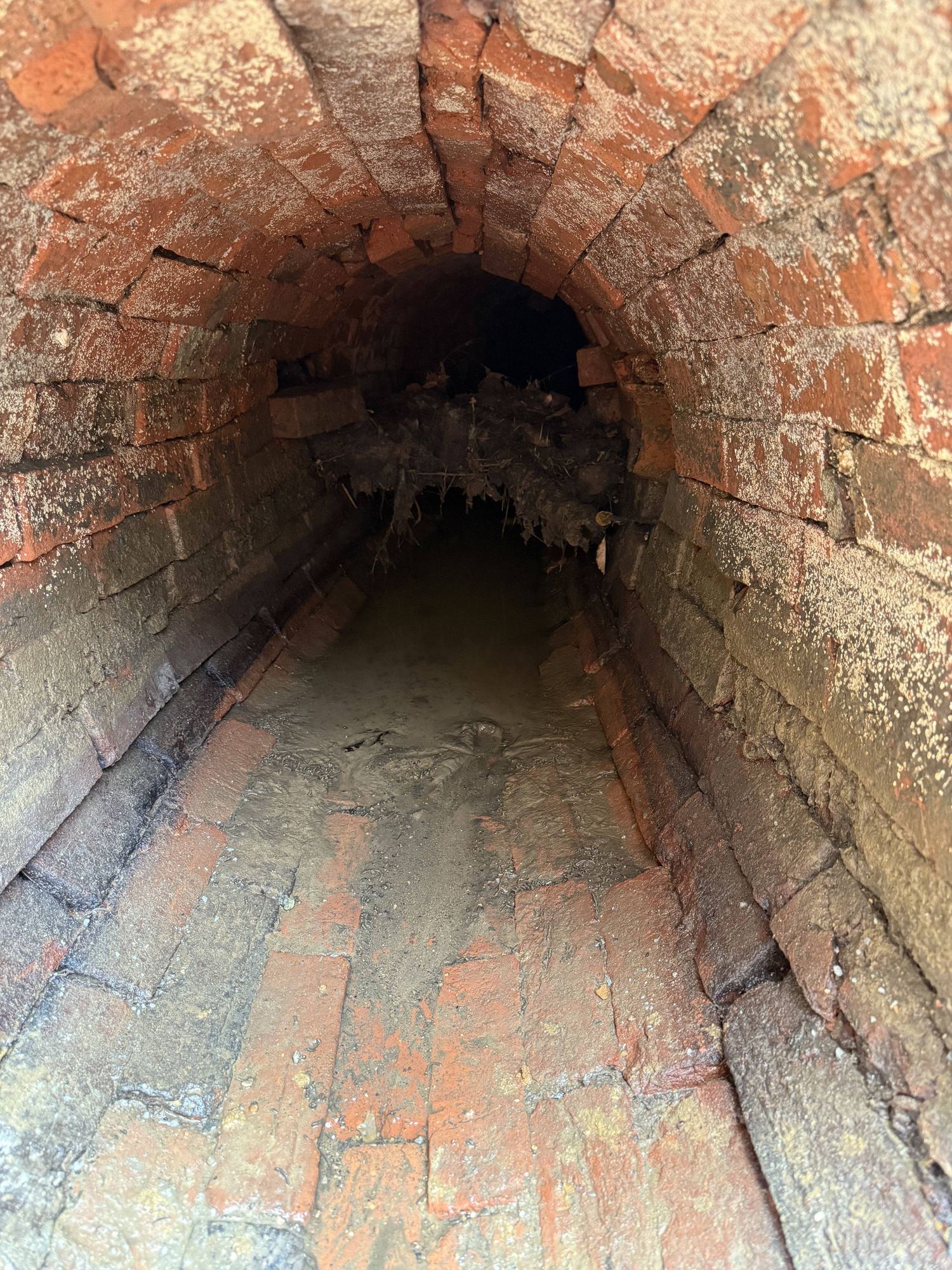 The Victorian brick culvert beneath the village — built in the 1800s and never upgraded