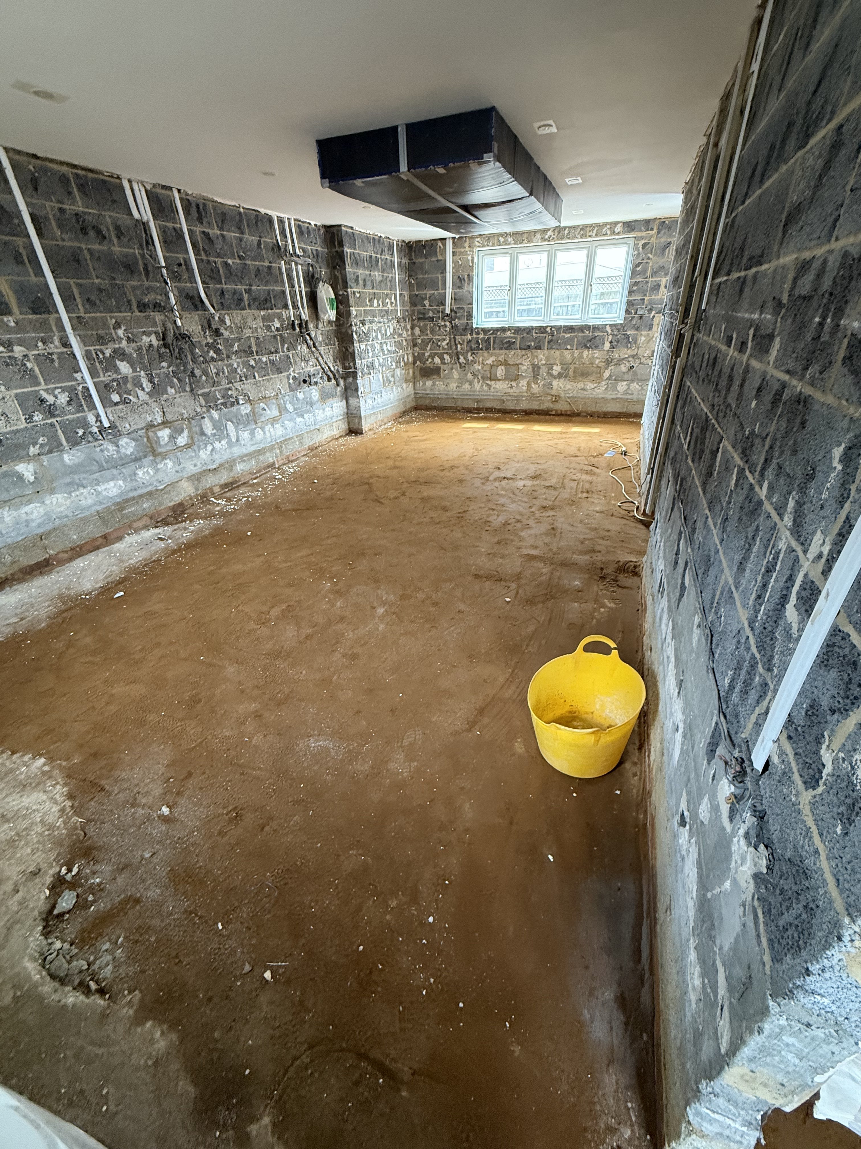 Stripped back to blinding sand — ready to receive the waterproof tanking mat