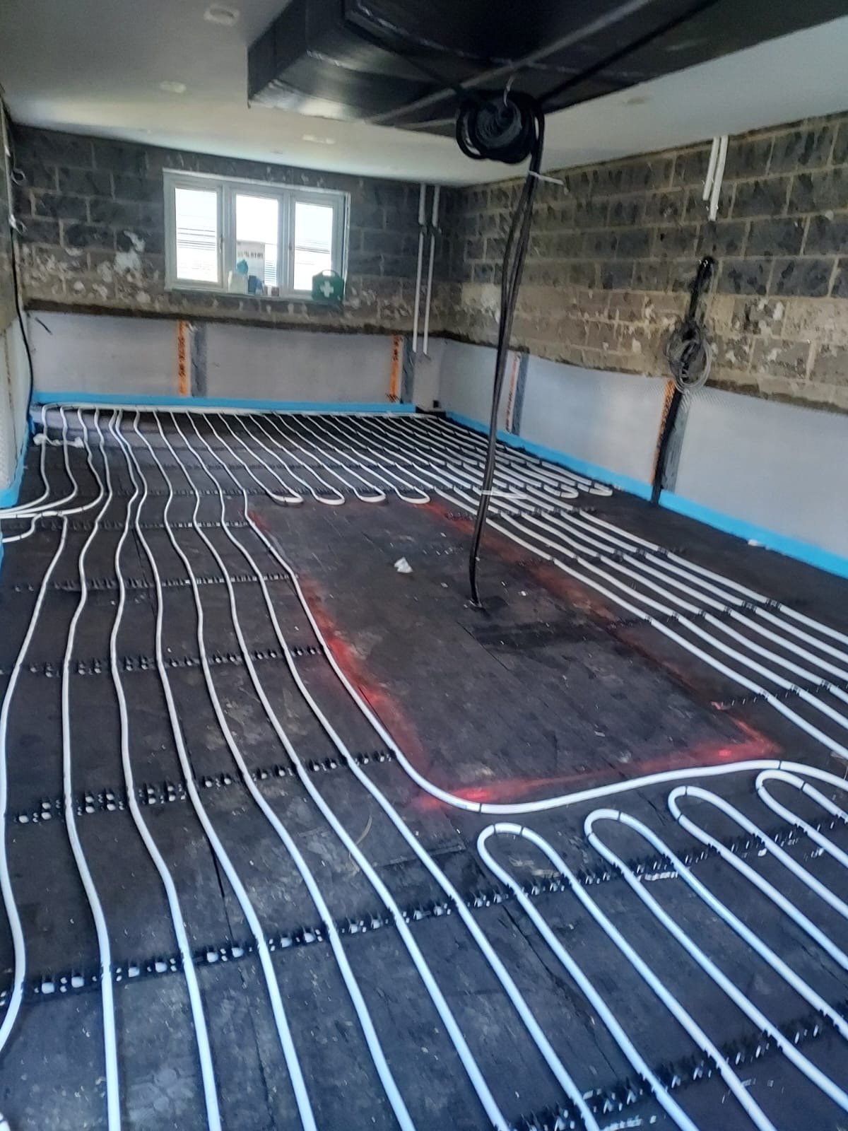 Kitchen floor — underfloor heating pipes laid and ready for screed, prior to the walls being battened out